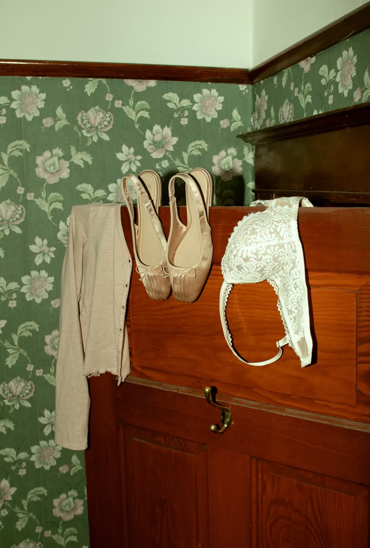 Lace body-care pieces arranged on an antique wooden wardrobe